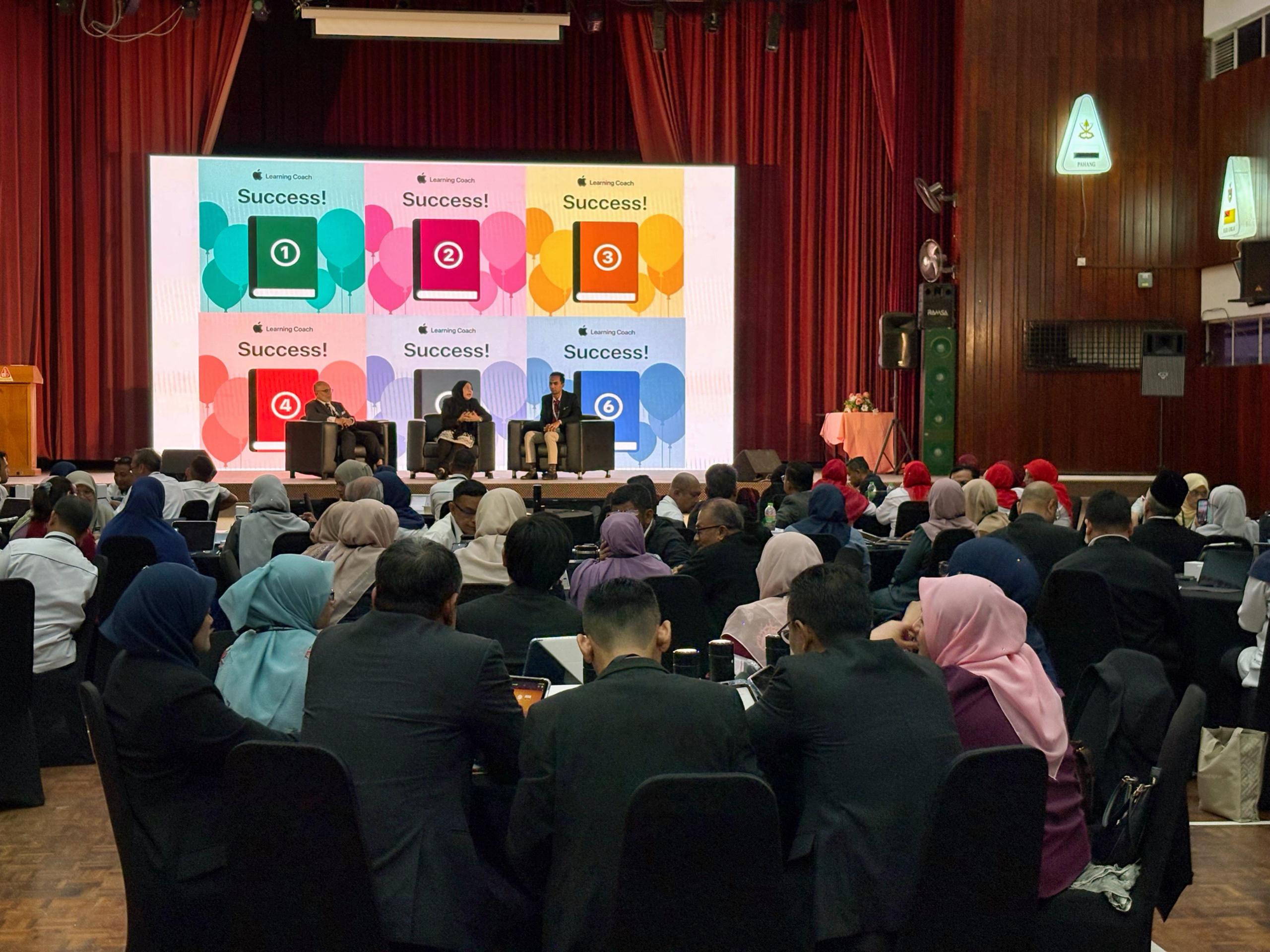 An education presentation in a large auditorium